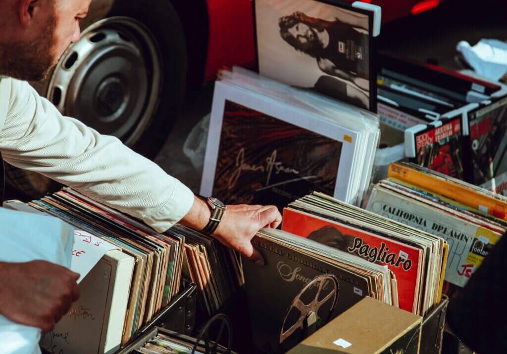 man sorting through records